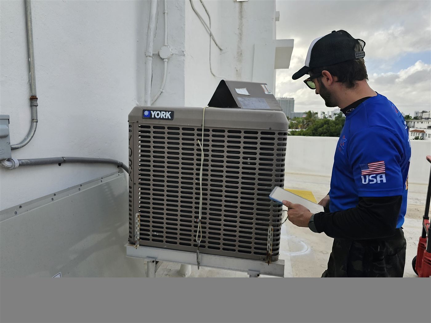 ACDR technician diagnosing a York condenser unit